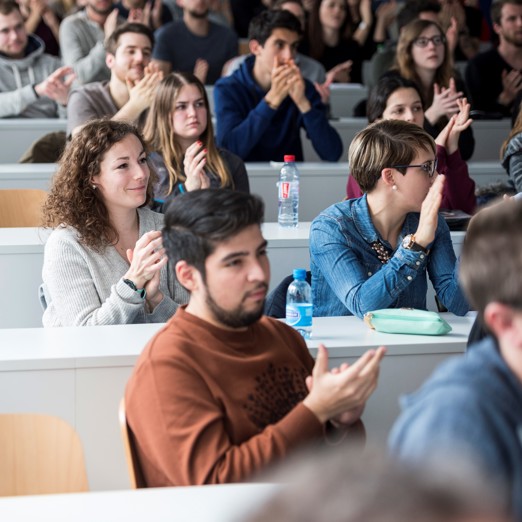 Eine Klasse von Schülern, die applaudieren. 